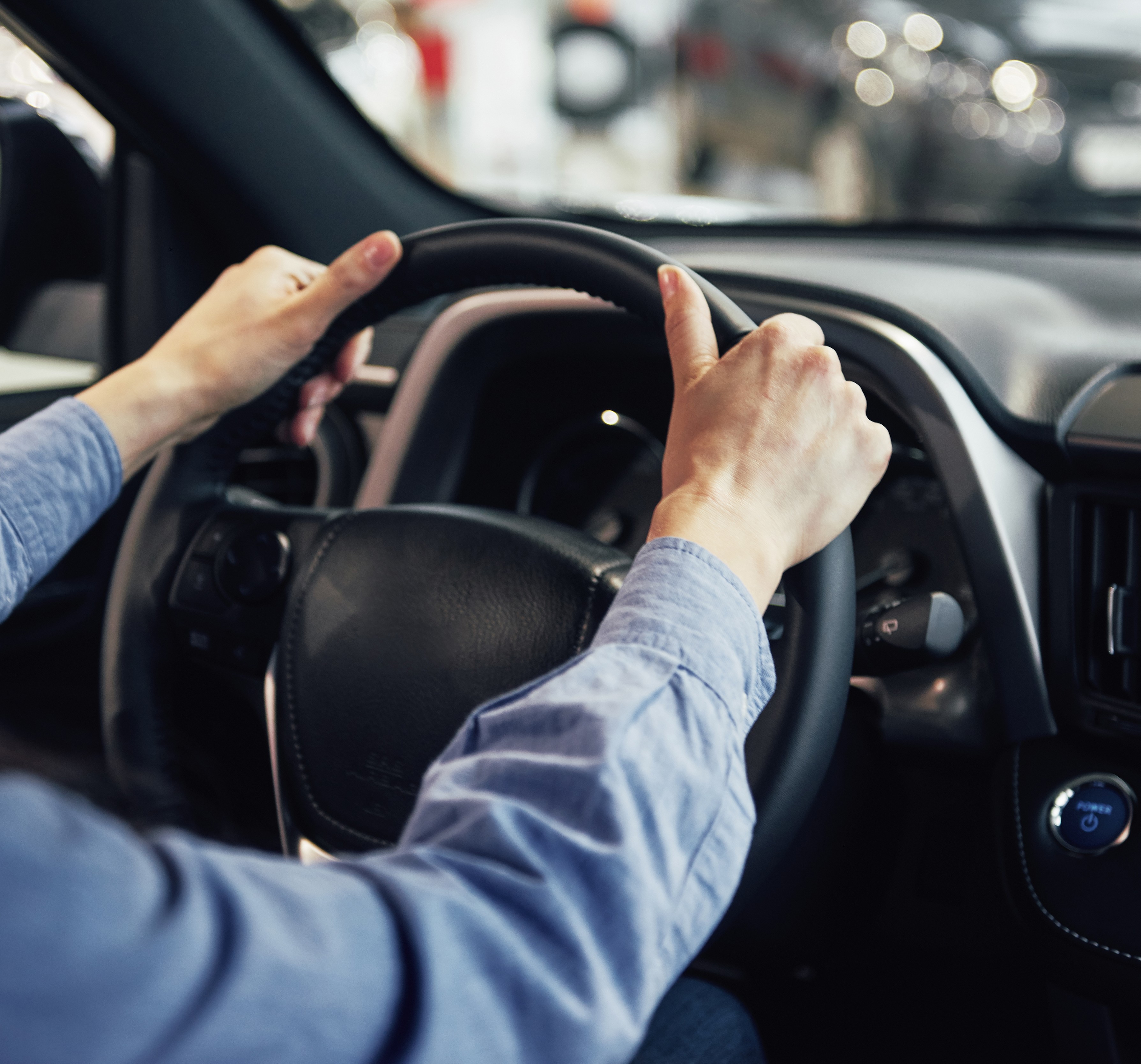 Driver's hands on a steering wheel